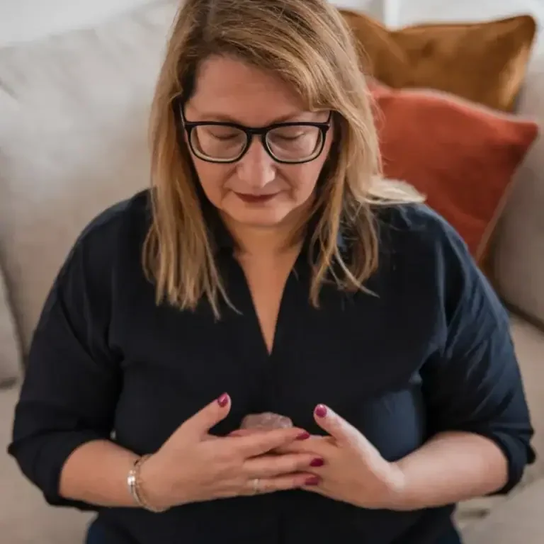 Woman practising conscious breathwork to reduce overwhelm and find greater clarity